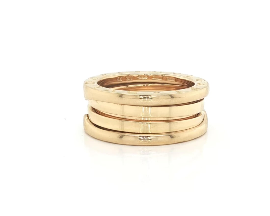 Size 8 B.zero1 Three-Band 18k Yellow Gold Ring by Bvlgari: Size 8 B.zero1 Three-Band 18k Yellow Gold Ring by Bvlgari The Bvlgari B.zero1 Three-Band Ring is expertly crafted in 18k yellow gold and features a polished finish. This iconic design from the B.zero1