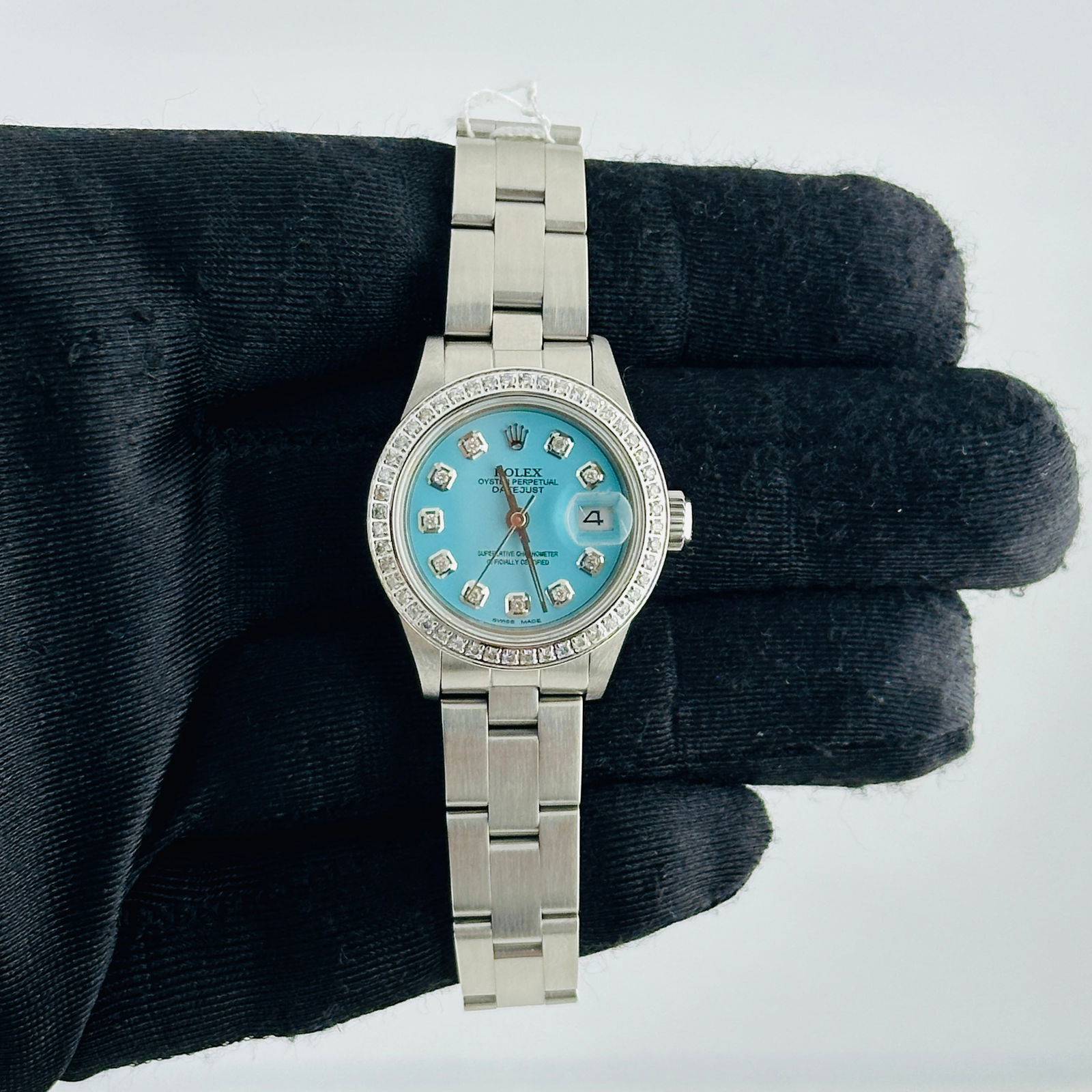 Ladies Datejust 69160 Oyster Bracelet With Aftermarket Tiffany Diamond Dial: Ladies Datejust 69160 Oyster Bracelet With Aftermarket Tiffany Diamond Dial This ladies' Rolex Datejust features an aftermarket Tiffany diamond dial and a pave diamond bezel. The watch is fitted with