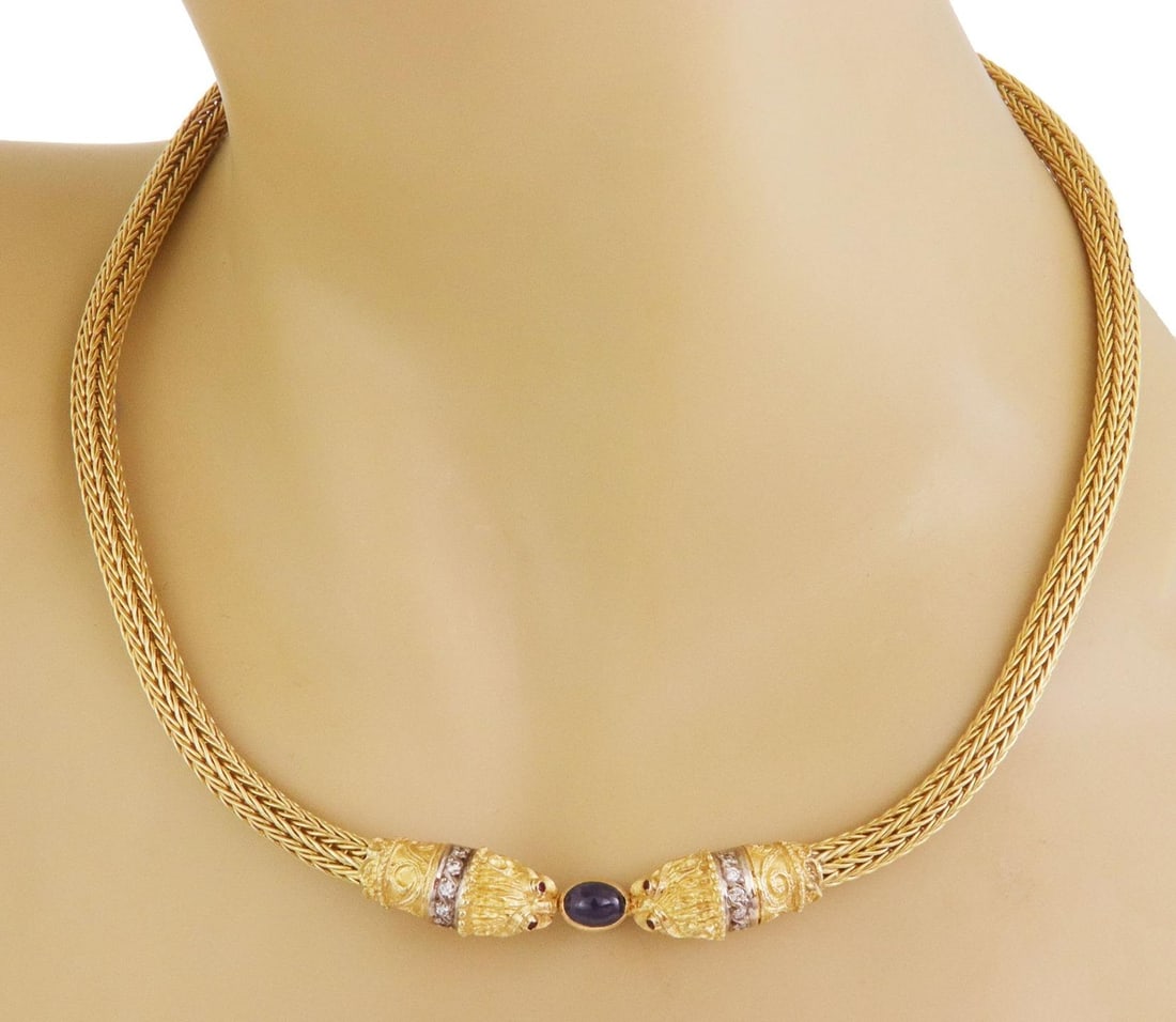 18k Two Tone Gold Lion Head Necklace with Sapphire and Diamonds: 18k Two Tone Gold Lion Head Necklace with Sapphire and Diamonds Make a bold statement with this exquisite collar necklace, expertly crafted from 18k yellow gold and accented with white gold. The strik
