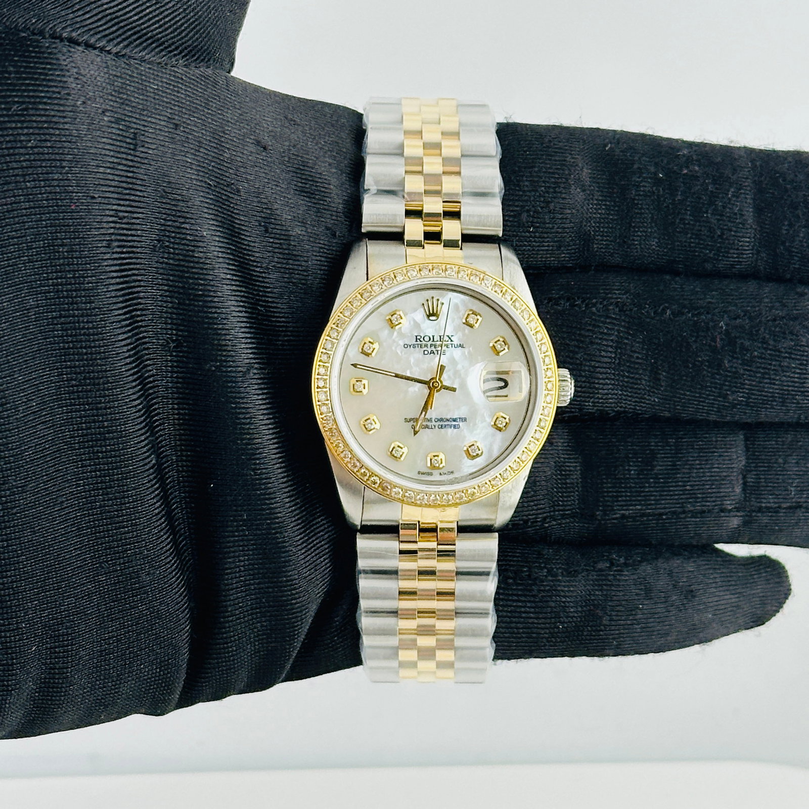 Unisex Rolex Ref 6694 With Aftermarket White MOP Diamond Dial Jubilee Bracelet: Unisex Rolex Ref 6694 With Aftermarket White MOP Diamond Dial Jubilee Bracelet This Rolex Oyster Perpetual Date watch, reference 6694, features a custom white mother of pearl diamond dial and a pave p