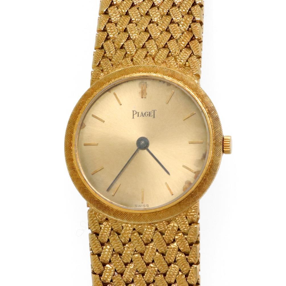 Piaget Vintage 18k Yellow Gold Hand Wind Ladies Watch: Piaget Vintage 18k Yellow Gold Hand Wind Ladies Watch This exquisite vintage wristwatch by Piaget is crafted from authentic 18k yellow gold, featuring a round coin-shaped case with a fine textured fin
