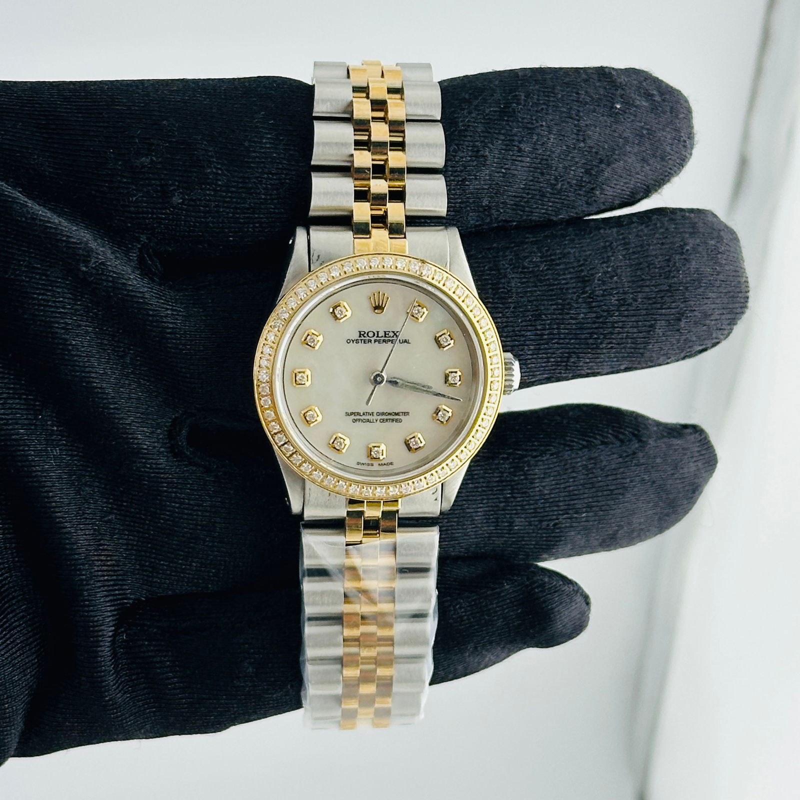 Aftermarket Diamond MOP Dial Rolex Oyster Perpetual Ref 6431 Ladies Watch: Aftermarket Diamond MOP Dial Rolex Oyster Perpetual Ref 6431 Ladies Watch This ladies' Rolex Oyster Perpetual features a white mother of pearl diamond dial and a pave plated diamond bezel. The watch i
