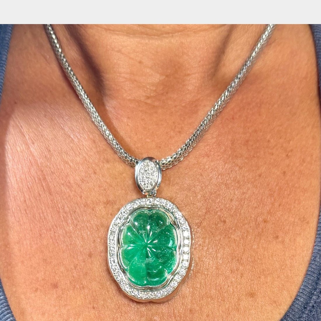 18K White Gold GIA Certified 60 Ct Emerald & 72 Diamonds Pendant: 18K White Gold GIA Certified 60 Ct Emerald & 72 Diamonds Pendant Discover the exquisite beauty of this 18K White Gold GIA Certified Carved Colombian Emerald & Diamond Pendant. This stunning piece feat