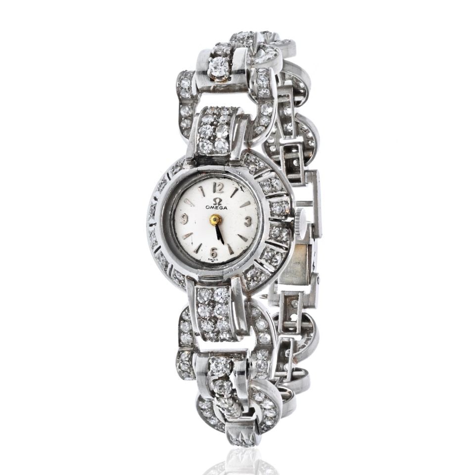 Omega Vintage 1940s Platinum Diamond Watch 12 Carats Mechanical: Omega Vintage 1940s Platinum Diamond Watch 12 Carats Mechanical This exquisite Omega vintage watch, crafted in the 1940s, showcases a luxurious platinum case adorned with a round dial and stick hour m