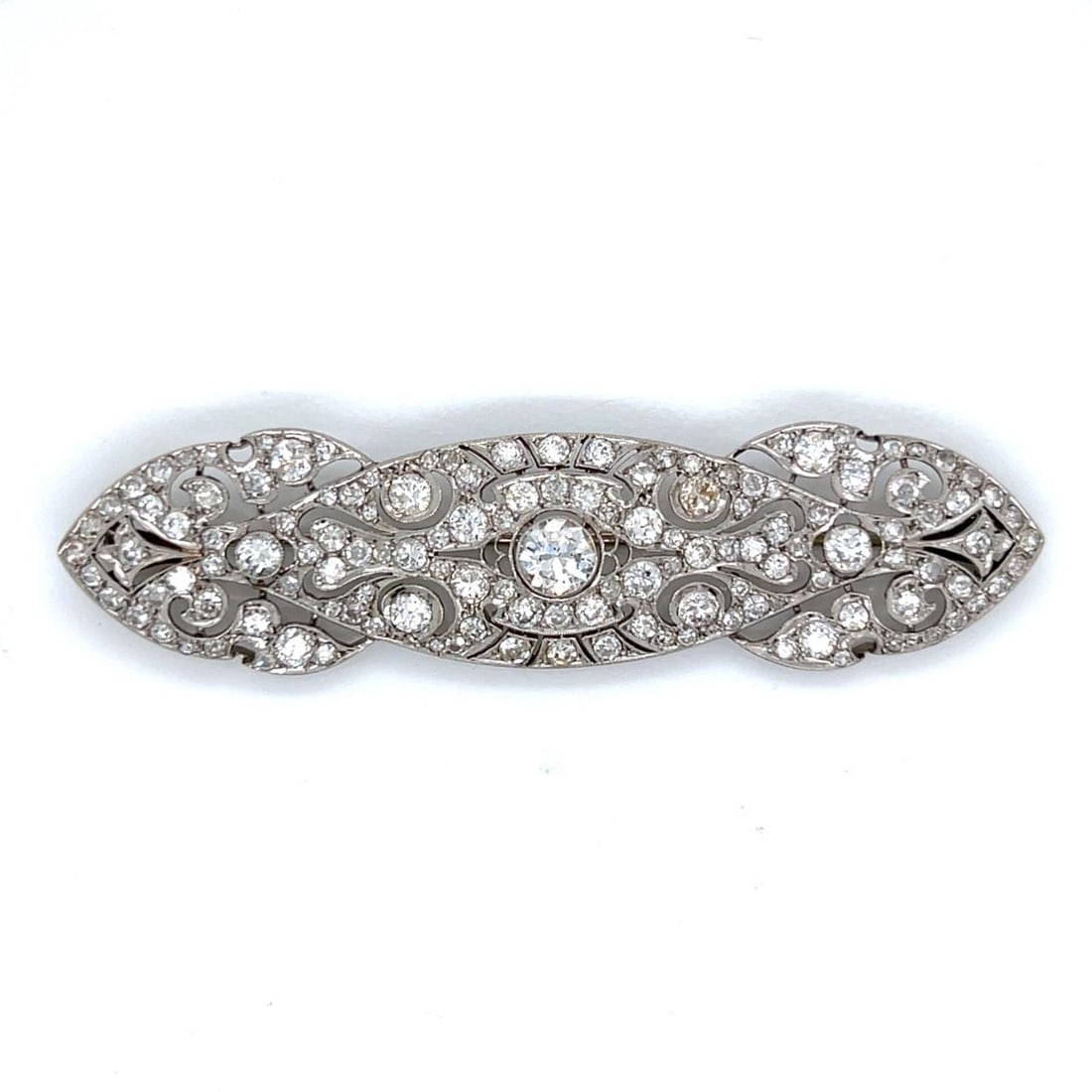 Platinum Art Deco Brooch with 6.25 Carat Diamonds and Center Stone: Platinum Art Deco Brooch with 6.25 Carat Diamonds and Center Stone This Art Deco brooch is crafted from platinum and features a total diamond weight of approximately 6.25 carats. The center is set wit