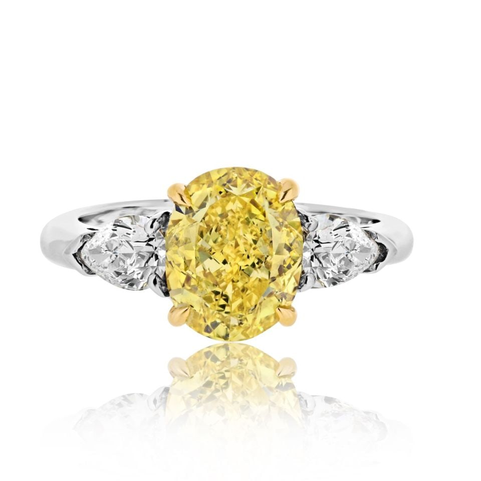 Fancy Vivid Yellow 2.53ct Oval Diamond Three Stone GIA Platinum Engagement Ring: Fancy Vivid Yellow 2.53ct Oval Diamond Three Stone GIA Platinum Engagement Ring This exquisite engagement ring features a stunning 2.53 carat Fancy Vivid Yellow oval cut diamond at its center, accompa