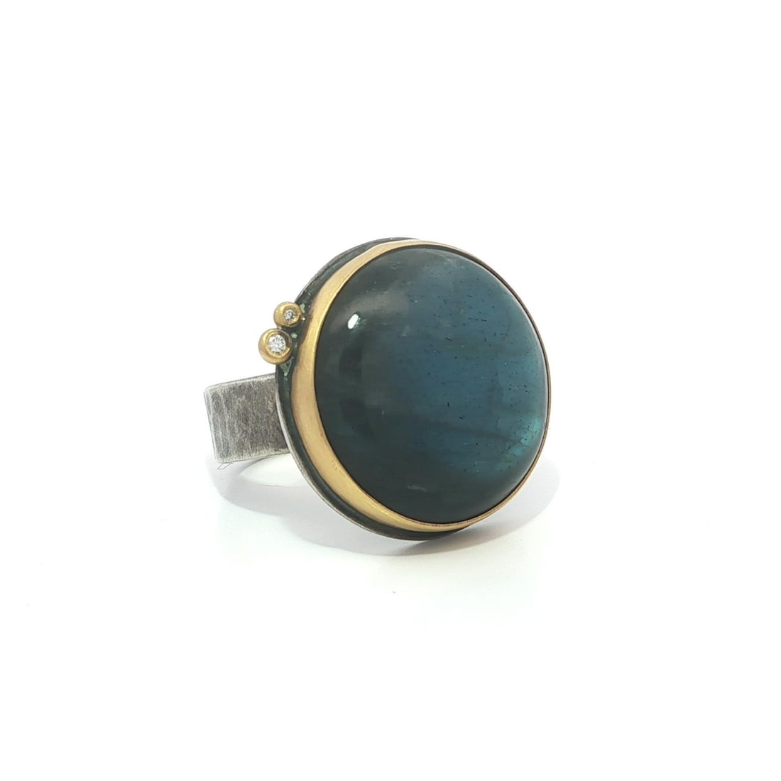 Labradorite and Diamond Cabochon Ring in Sterling Silver and 22k Yellow Gold: Labradorite and Diamond Cabochon Ring in Sterling Silver and 22k Yellow Gold This elegant cocktail ring features a smooth round cabochon-cut natural labradorite as its centerpiece, accented by two nat