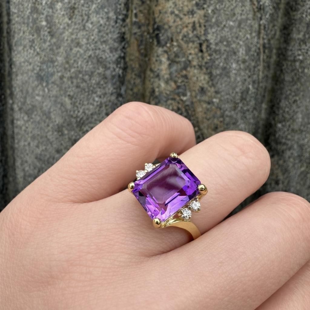 Cocktail Ring with Emerald Cut Amethyst and Diamonds in 14k Yellow Gold: Cocktail Ring with Emerald Cut Amethyst and Diamonds in 14k Yellow Gold This women's cocktail ring features a natural emerald cut amethyst set in solid 14k yellow gold. The amethyst is accented by fou