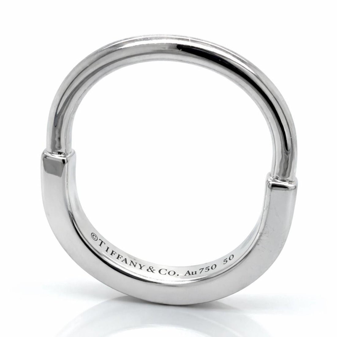 18K White Gold Band by Tiffany & Co Size 5: 18K White Gold Band by Tiffany & Co Size 5 This Tiffany & Co. ring is crafted from 18K white gold and weighs 5.2 grams. It is a pre-owned piece in a ring size 5. Specifications Brand: Tiffany & Co. Ma