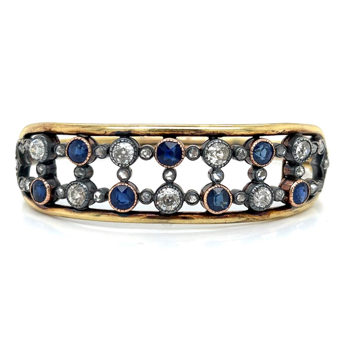 Victorian 18K Yellow Gold Bangle with Burma Sapphires and Diamonds: Victorian 18K Yellow Gold Bangle with Burma Sapphires and Diamonds This exquisite Victorian bangle is crafted from 18K yellow gold and features a stunning combination of Burma sapphires and old mine d