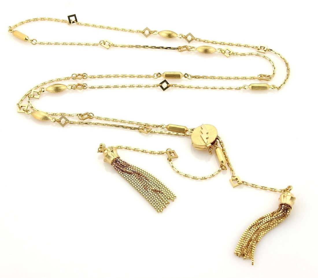 Vintage 18k Yellow Gold Lariat Necklace with Long Chain and Tassel Detail: Vintage 18k Yellow Gold Lariat Necklace with Long Chain and Tassel Detail This vintage lariat necklace features a fancy design crafted in 18k yellow gold. The long chain is adorned with a tassel detai