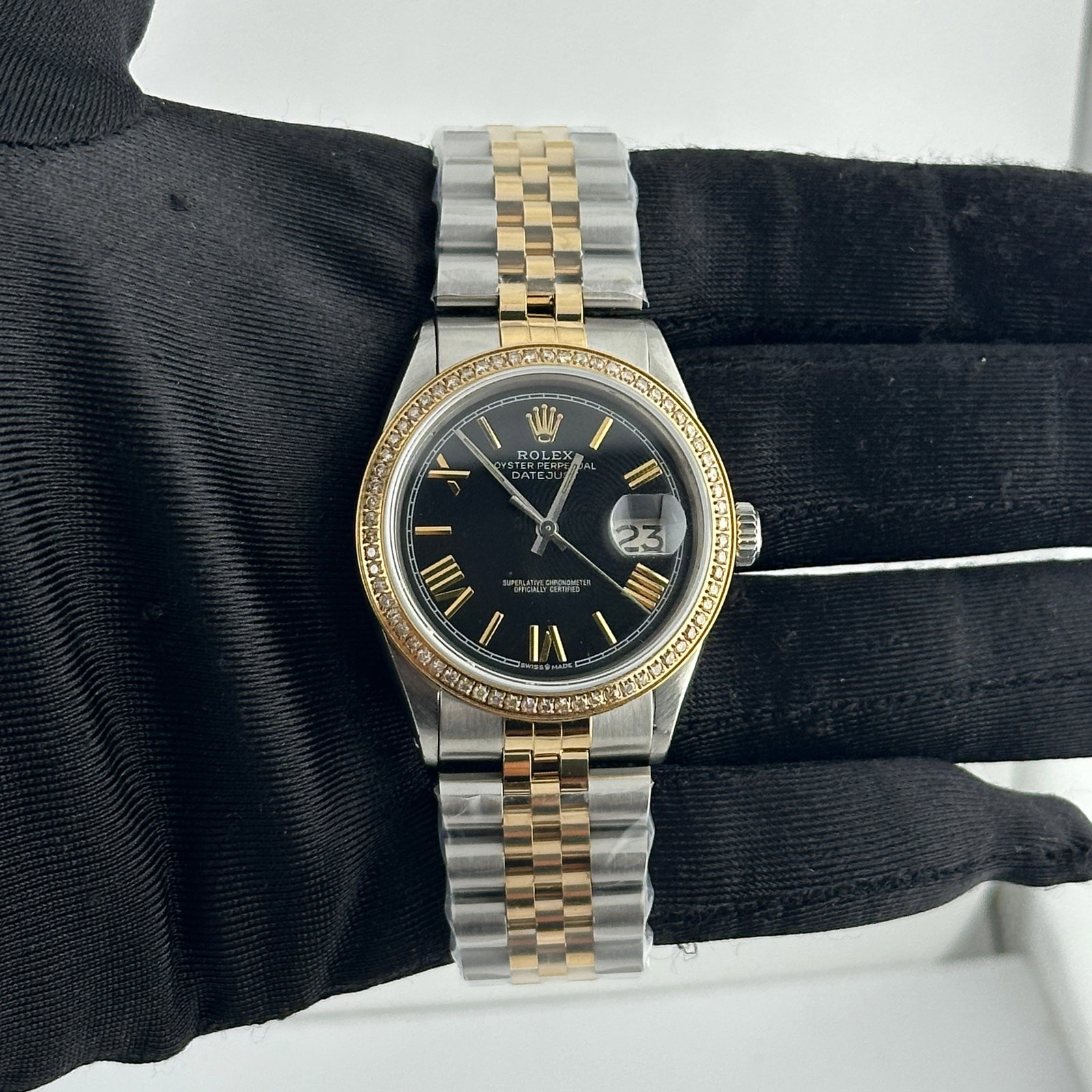 Rolex Datejust 1601 Aftermarket Black Roman Dial Jubilee Watch: Rolex Datejust 1601 Aftermarket Black Roman Dial Jubilee Watch This Rolex Datejust features an aftermarket black dial with Roman stick markers, a pave plated diamond bezel, and an aftermarket Jubilee