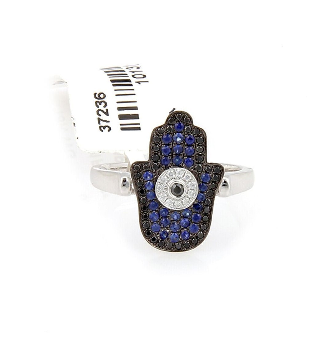 18k White Gold Hamsa Evil Eye Ring with Diamonds and Blue Black Sapphires Size 6.5: 18k White Gold Hamsa Evil Eye Ring with Diamonds and Blue Black Sapphires Size 6.5 This Evil Eye Hamsa ring is crafted from 18k white gold and features black and blue sapphires along with 0.22ct of di