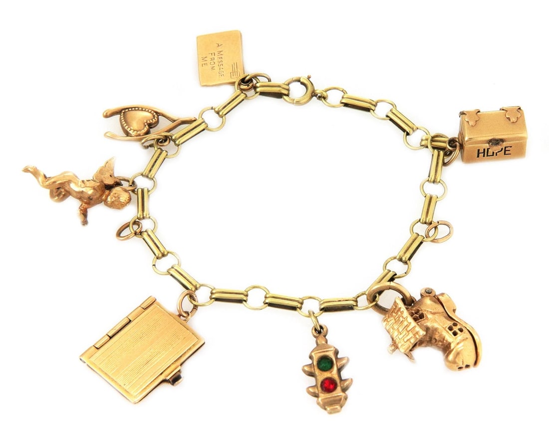 Vintage 14k Yellow Gold Charm Bracelet with 7 Assorted Charms: Vintage 14k Yellow Gold Charm Bracelet with 7 Assorted Charms This vintage charm bracelet is beautifully crafted from 14k yellow gold, showcasing a unique design with round and elongated links. Adorne