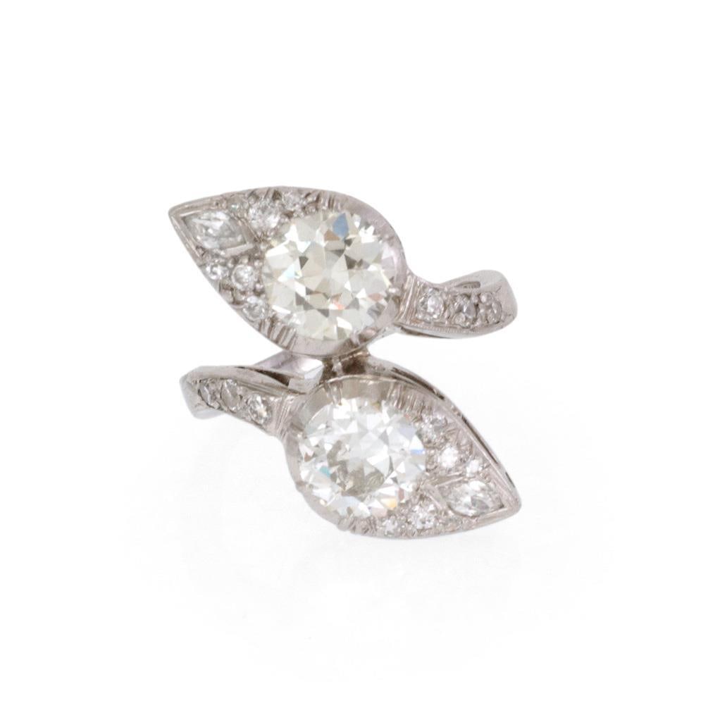 Art Deco Platinum Bypass Ring with Old Mine Cut Diamonds: Art Deco Platinum Bypass Ring with Old Mine Cut Diamonds This exquisite Art Deco ring is meticulously crafted from platinum, showcasing a unique bypass design that features a striking spear-shaped for