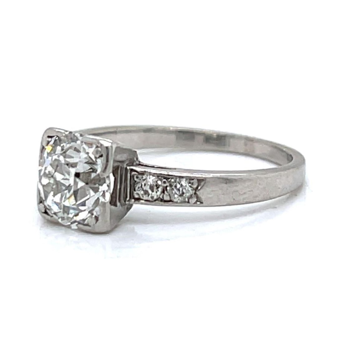 Art Deco Platinum 1.50 Ct Diamond Ring with Old Mine Diamonds: Art Deco Platinum 1.50 Ct Diamond Ring with Old Mine Diamonds This exquisite Art Deco ring showcases a stunning 1.50 Ct. European-cut diamond at its center, exhibiting a beautiful J color and VVS clar