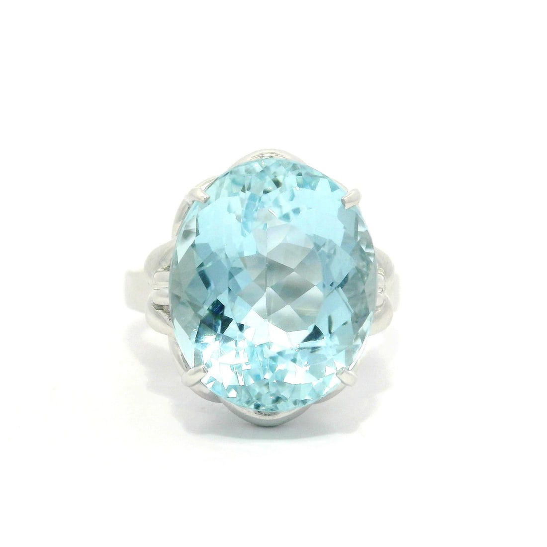 Platinum GIA 7.05ct Oval Aquamarine Floral Solitaire Ring: Platinum GIA 7.05ct Oval Aquamarine Floral Solitaire Ring This exquisite solitaire ring features a stunning 7.05ct oval cut aquamarine, prong set to showcase its vibrant blue color. Crafted from solid