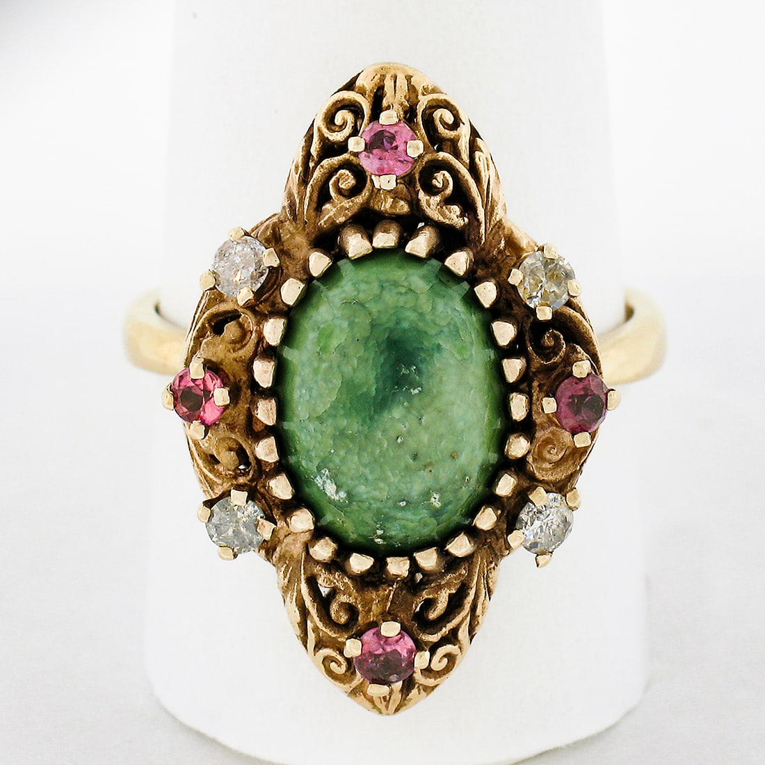 Vintage 14K Yellow Gold Turquoise Diamond Ruby Cocktail Ring: Vintage 14K Yellow Gold Turquoise Diamond Ruby Cocktail Ring This stunning vintage cocktail ring is crafted from solid 14K yellow gold, showcasing a captivating oval cabochon cut green turquoise at it