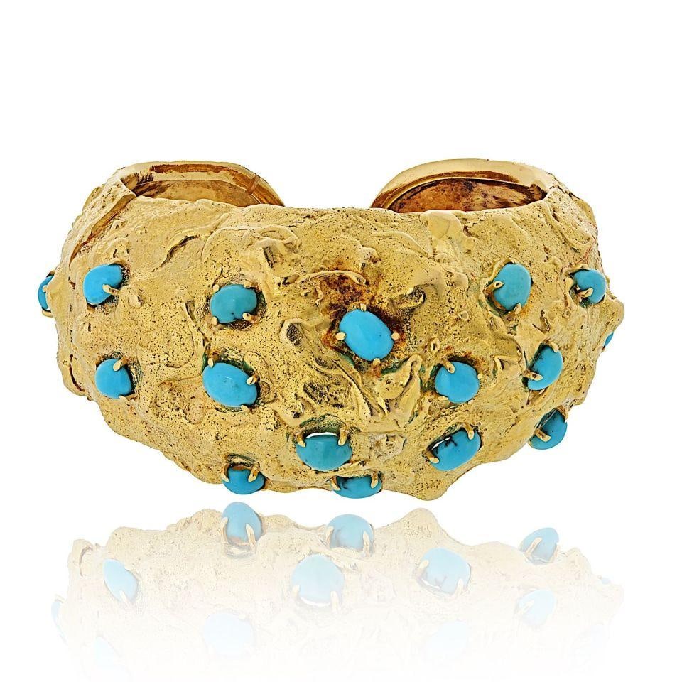 Hammered Turquoise Cabochon Cuff in Platinum and 18K Gold by David Webb: Hammered Turquoise Cabochon Cuff in Platinum and 18K Gold by David Webb This cuff bracelet by David Webb features a striking combination of platinum and 18K yellow gold with a hammered finish. It is a