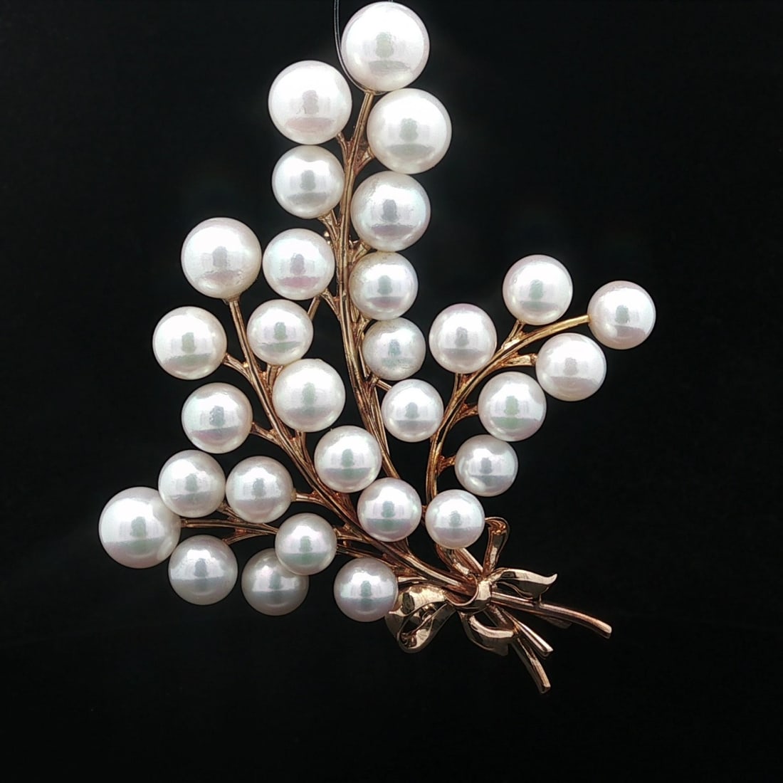 Brooch Featuring AAA Cultured Pearls in 14k Yellow Gold Feather Bouquet Design: Brooch Featuring AAA Cultured Pearls in 14k Yellow Gold Feather Bouquet Design This Mikimoto brooch is crafted from 14k solid yellow gold and features a feather bouquet design accented with a ribbon.