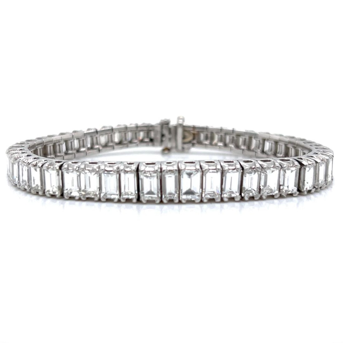 Platinum Diamond Tennis Bracelet with 15 Carats Emerald Cuts Art Deco Era: Platinum Diamond Tennis Bracelet with 15 Carats Emerald Cuts Art Deco Era This Art Deco platinum tennis bracelet features a graduated design set with 50 emerald-cut diamonds totaling approximately 15.