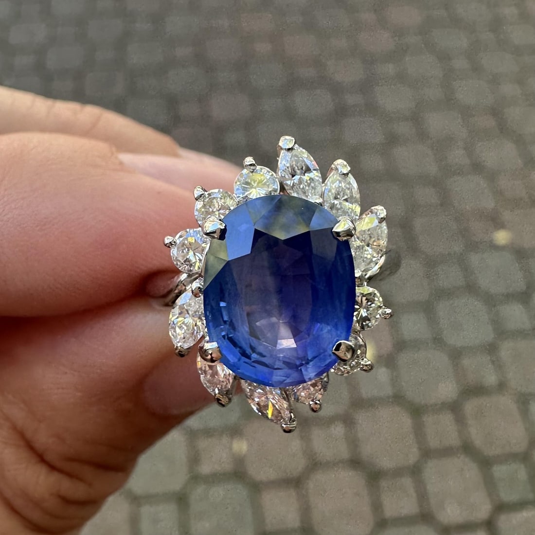 Platinum AGL 6.82ctw Ceylon Blue Sapphire Diamond Halo Cocktail Ring: Platinum AGL 6.82ctw Ceylon Blue Sapphire Diamond Halo Cocktail Ring This exquisite cocktail ring features a stunning natural oval-cut sapphire, weighing 5.60 carats. The velvety blue color is enhance