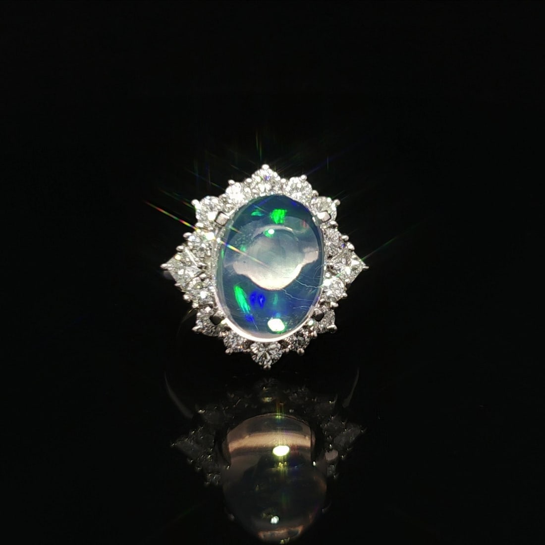 Stunning 7.52ctw Natural Jelly Opal Platinum Ring with Diamond Halo: Stunning 7.52ctw Natural Jelly Opal Platinum Ring with Diamond Halo This stunning statement ring features a captivating 7.52 carat total weight with a fiery jelly opal at its center. The natural genui