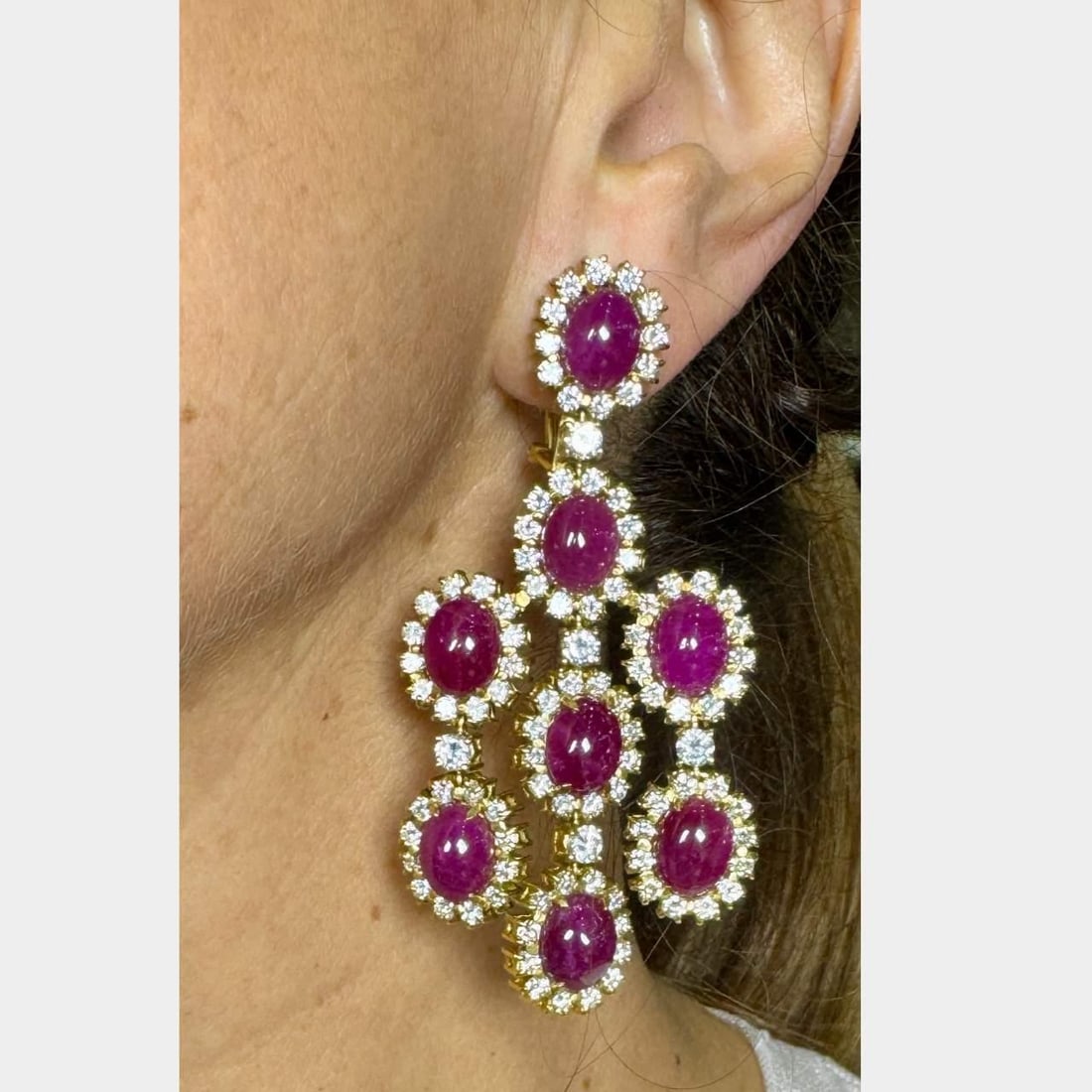 Stunning 18K Yellow Gold Ruby 60.00 Ct & Diamond 14.40 Ct Earrings: Stunning 18K Yellow Gold Ruby 60.00 Ct & Diamond 14.40 Ct Earrings Elegant 18K yellow gold earrings adorned with a stunning array of diamonds and rubies. These earrings feature 16 rubies with a total