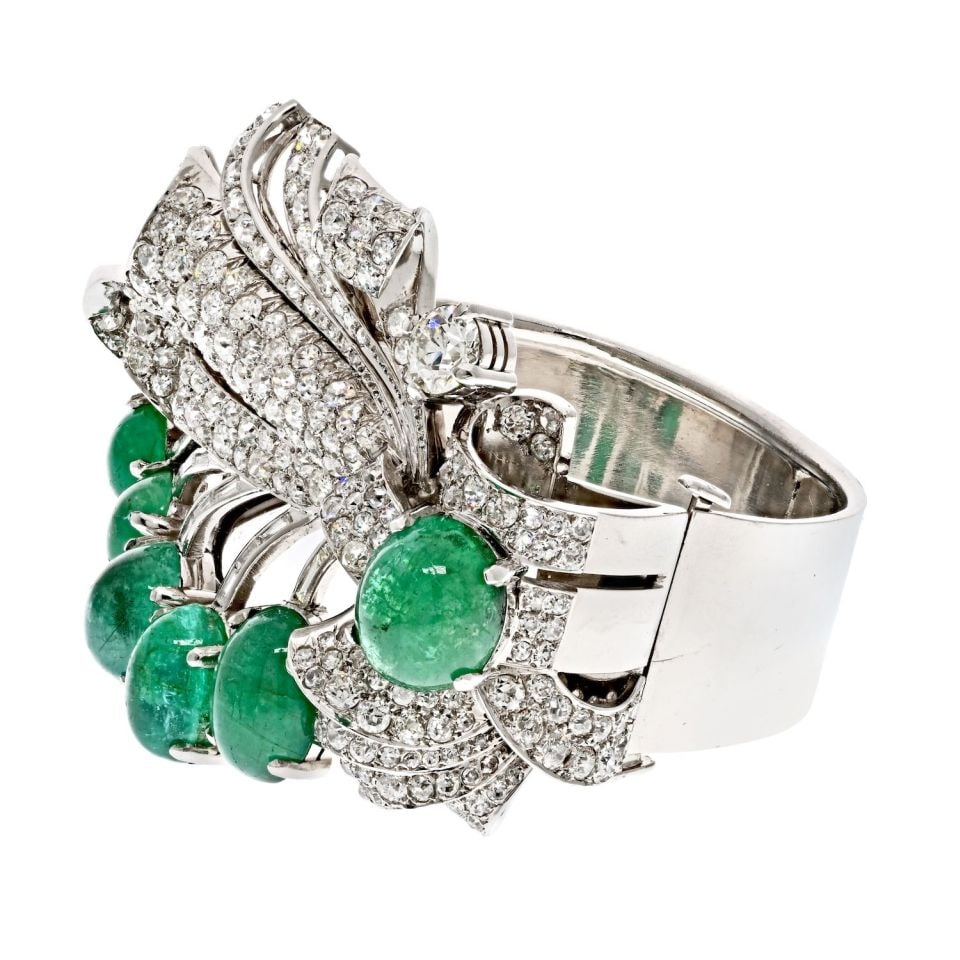 1940's Platinum Floral Bracelet with 75ct Green Emeralds and 22ct Diamonds: 1940's Platinum Floral Bracelet with 75ct Green Emeralds and 22ct Diamonds Discover the elegance of this exquisite Platinum 1940's Cabochon Cut Green Emerald and Diamond Bracelet. This stunning piece