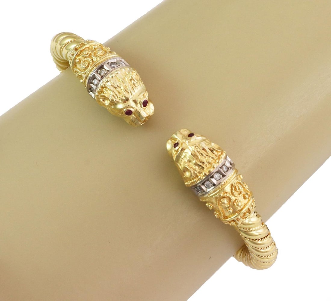 18k Gold Double Griffin Lion Head Cuff Bracelet with Diamonds and Rubies: 18k Gold Double Griffin Lion Head Cuff Bracelet with Diamonds and Rubies This exquisite hinge cuff bracelet features a stunning design of double griffin or lion heads crafted from both 18k yellow and