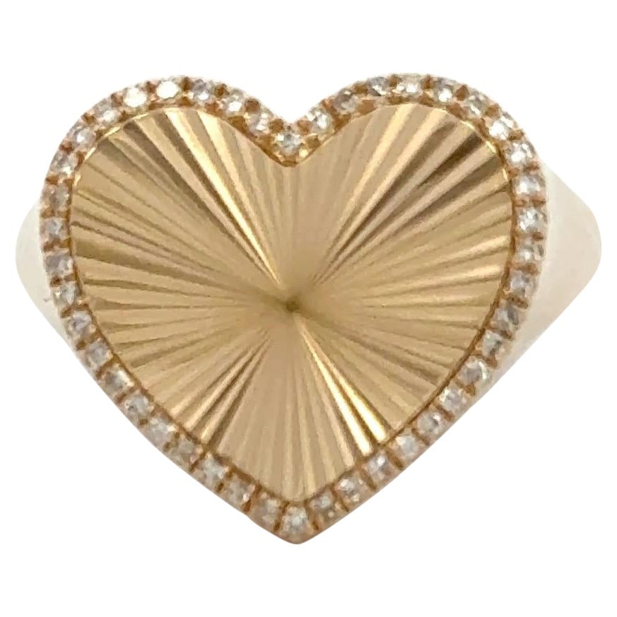 Heart Shaped 14K Yellow Gold Ring with 0.12ct Diamond Halo: Heart Shaped 14K Yellow Gold Ring with 0.12ct Diamond Halo This romantic and elegant ring is crafted in solid 14K yellow gold and features a sunburst-finished heart center surrounded by a sparkling ha