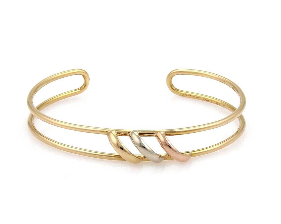 Trinity 18k Tri-Color Gold Double Wire Cuff Bracelet by Cartier with Paper: Trinity 18k Tri-Color Gold Double Wire Cuff Bracelet by Cartier with Paper This Cartier Trinity open double wire cuff bracelet is crafted from 18k yellow, rose, and white gold. Featuring Cartier's ico