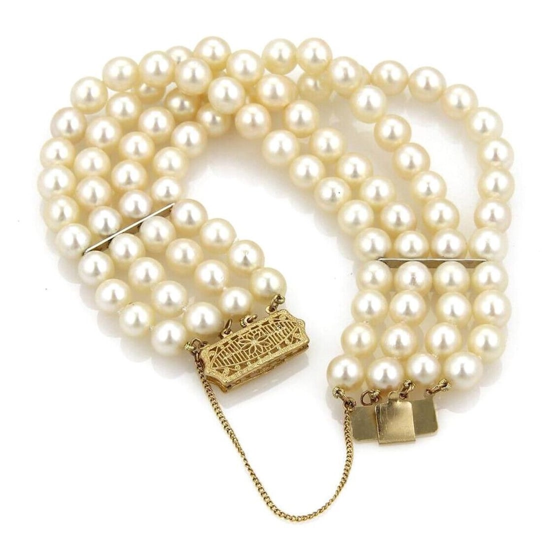 Four Strand 7mm Pearl Bracelet with 14k Yellow Gold Filigree Clasp: Four Strand 7mm Pearl Bracelet with 14k Yellow Gold Filigree Clasp This vintage bracelet features four strands of creamy 7 mm pearls, elegantly set with a rectangular box clasp crafted in 14k yellow g