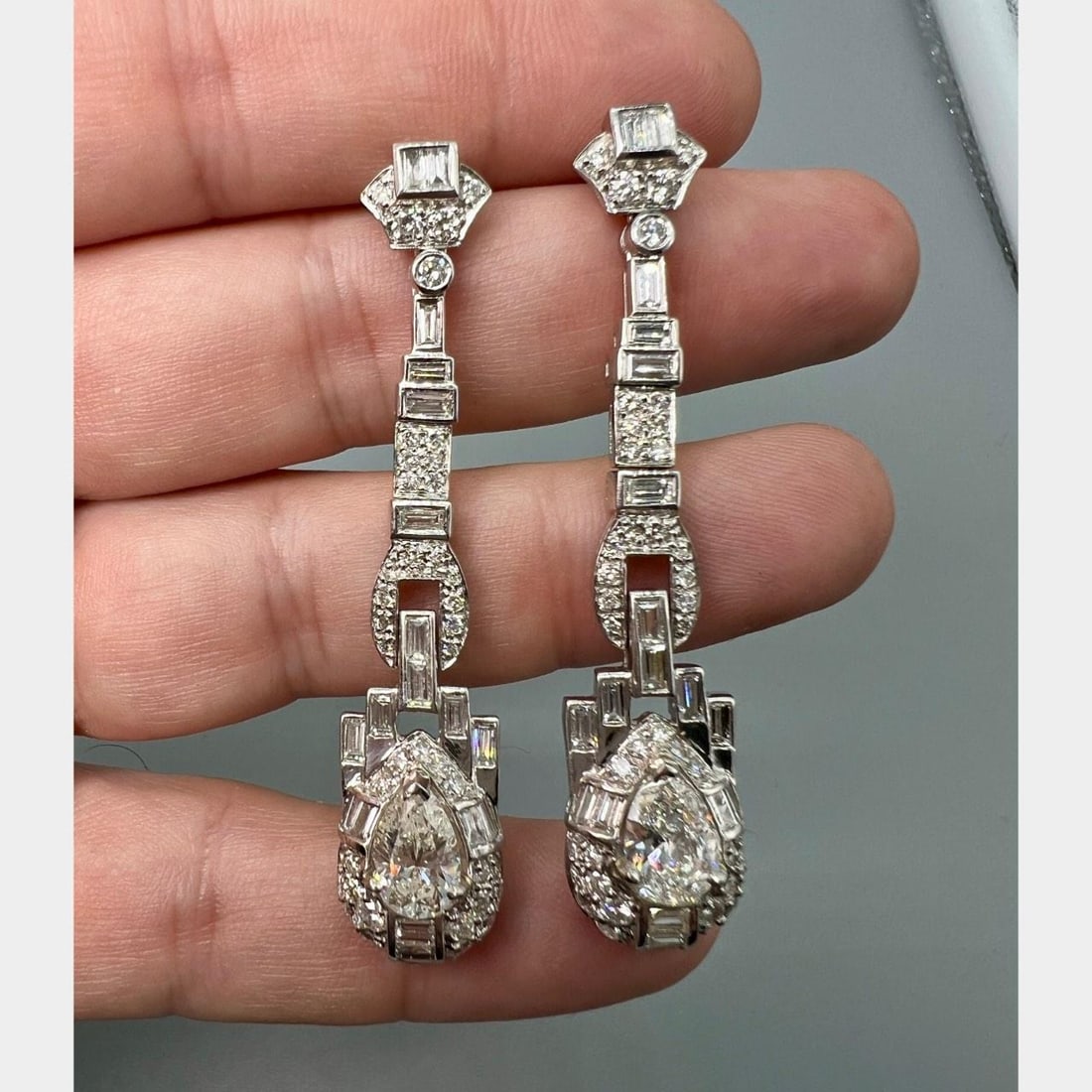 Platinum Diamond Earrings 6.70 Carat with Old Pear Shapes and Accents: Platinum Diamond Earrings 6.70 Carat with Old Pear Shapes and Accents Elegant platinum earrings featuring two old pear-shaped diamonds with a combined weight of approximately 2.20 carats, H-I color, a