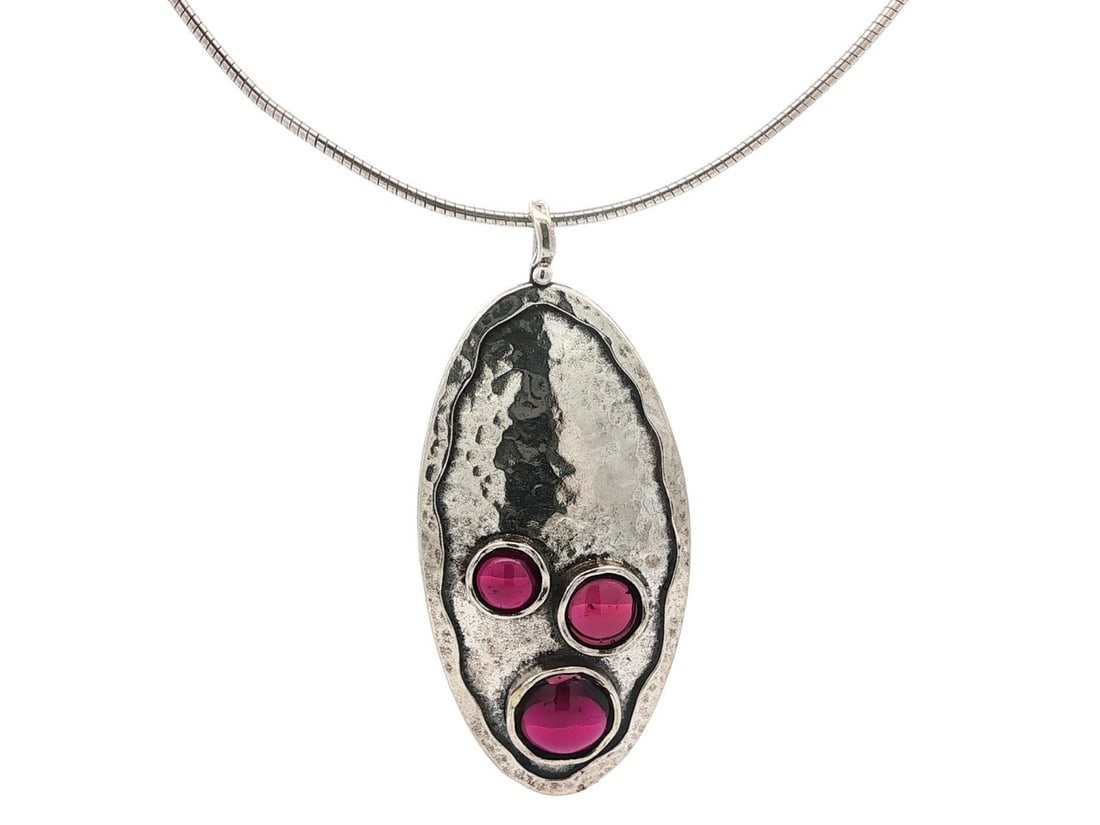 Sterling Silver Hammered Pendant Necklace with Natural Garnet: Sterling Silver Hammered Pendant Necklace with Natural Garnet This exquisite necklace features a large oval pendant crafted from .925 sterling silver, showcasing a stunning natural garnet cabochon. Th