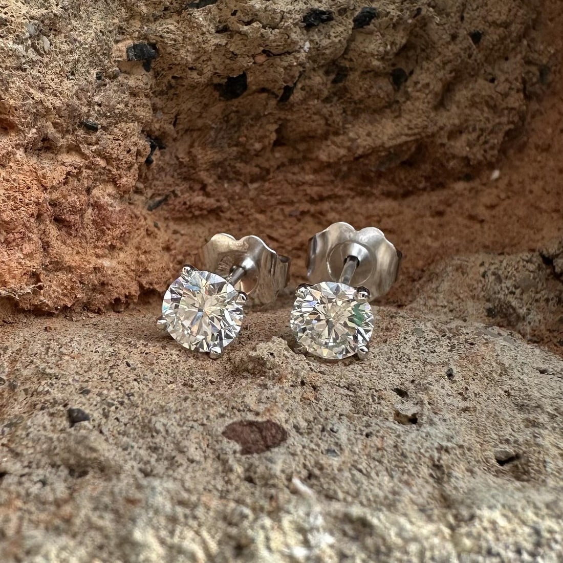 Pair of 0.71ctw H VS Natural Diamond Studs in 14k White Gold Martini Setting: Pair of 0.71ctw H VS Natural Diamond Studs in 14k White Gold Martini Setting These un-used stud earrings feature two natural round brilliant cut diamonds, each set in a martini 4-prong setting. The di