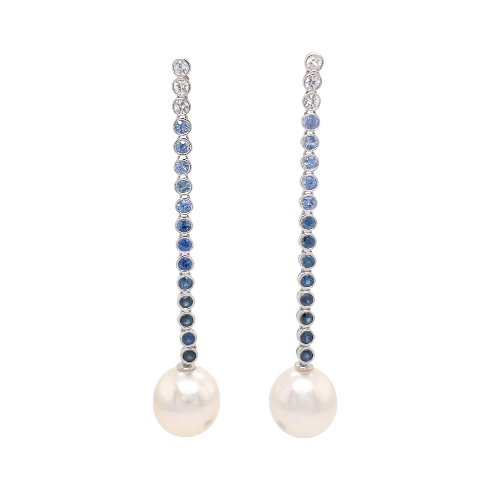 Contemporary White Gold Drop Earrings with Ombree Sapphires and South Sea Pearls: Contemporary White Gold Drop Earrings with Ombree Sapphires and South Sea Pearls Elevate your elegance with these stunning 18 Karat White Gold Sapphire Ombree Pearl Drop Earrings. Crafted from high-qu