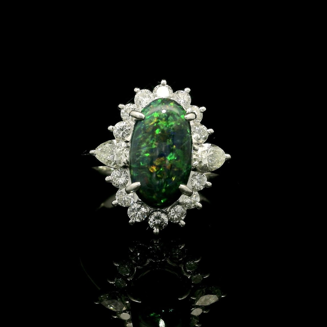 Platinum GIA Certified 3.65ct Black Opal Diamond Halo Ring: Platinum GIA Certified 3.65ct Black Opal Diamond Halo Ring This exquisite cocktail ring showcases a stunning elongated oval black opal, certified by GIA, and is beautifully framed by a halo of natural