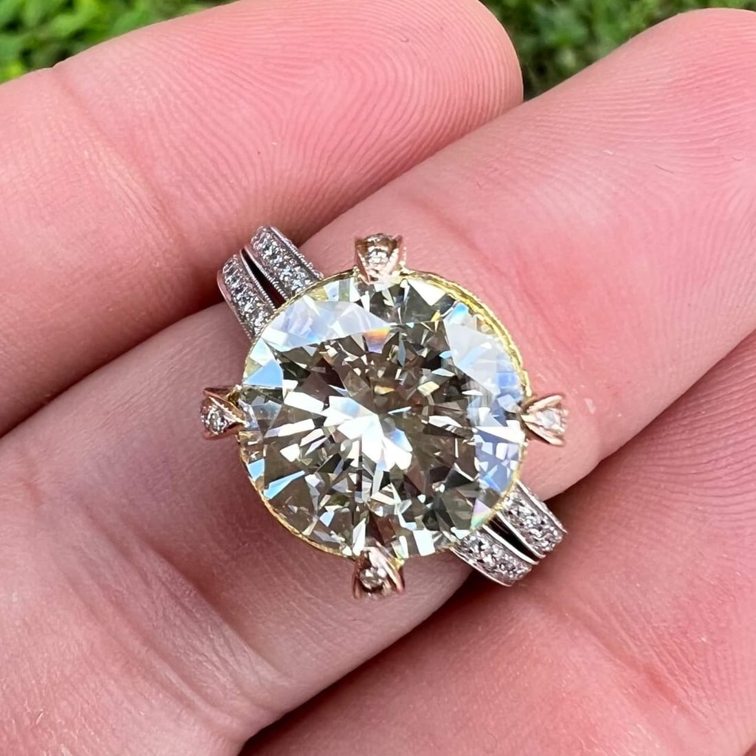 18K Gold Diamond Ring 4.52 Ct Round VVS M Color: 18K Gold Diamond Ring 4.52 Ct Round VVS M Color This stunning ring features a luxurious combination of 18K yellow and white gold, showcasing a magnificent 4.52 Ct. round diamond at its center. The dia