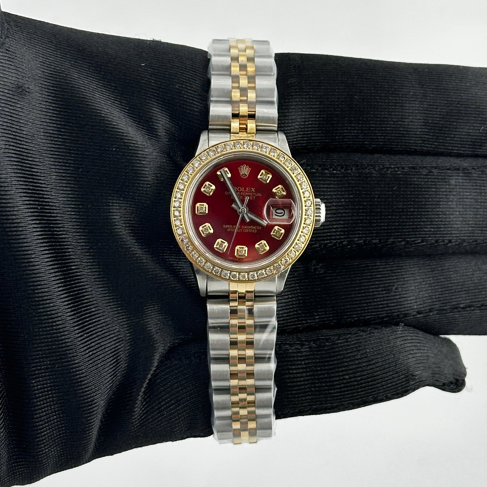 Ladies Datejust Reference 6516 Red Diamond Dial Aftermarket Jubilee Bracelet: Ladies Datejust Reference 6516 Red Diamond Dial Aftermarket Jubilee Bracelet This ladies' Rolex Datejust watch features an aftermarket red diamond dial and pave plated diamond bezel. It is equipped wi