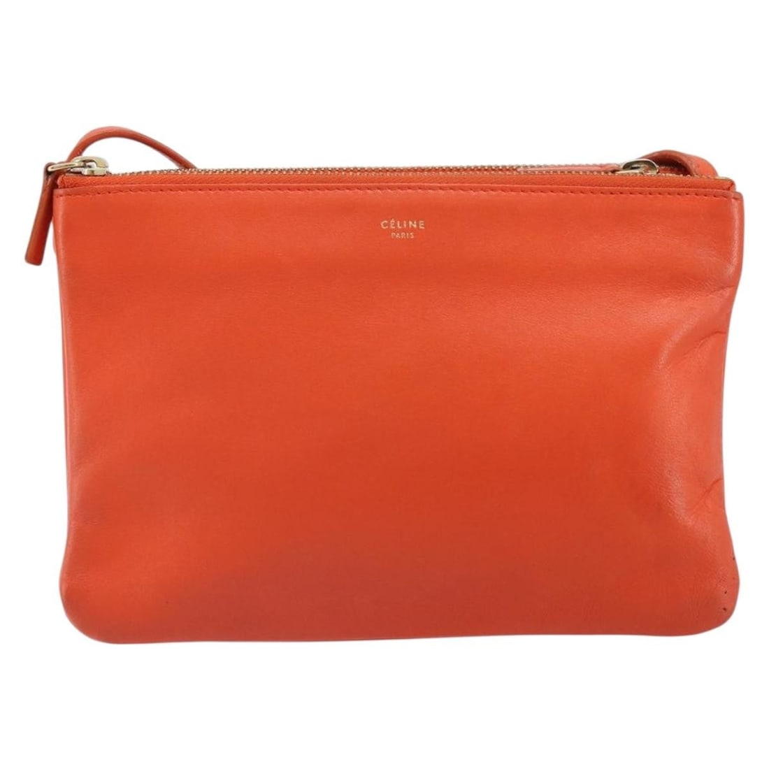 Celine Trio Orange Leather Crossbody Purse with Strap: Celine Trio Orange Leather Crossbody Purse with Strap This Celine Trio Crossbody Bag features an orange leather exterior and is designed for women. The bag includes a shoulder strap and metal fittings