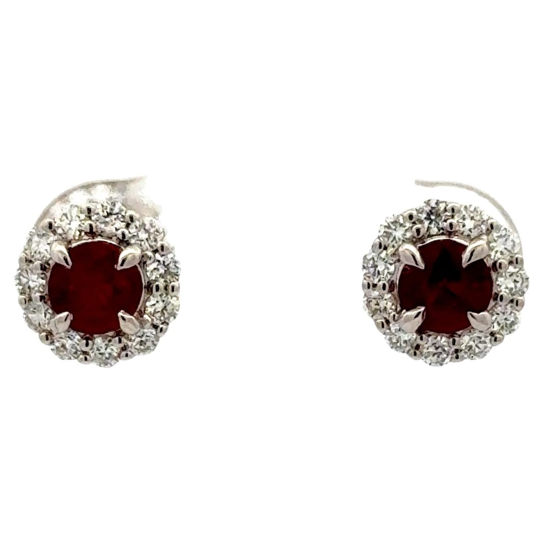 Pair of Ruby and Diamond Halo Earrings in 14K White Gold: Pair of Ruby and Diamond Halo Earrings in 14K White Gold These elegant stud earrings feature round-cut rubies encircled by a halo of sparkling round brilliant diamonds, set in 14K white gold. The clas