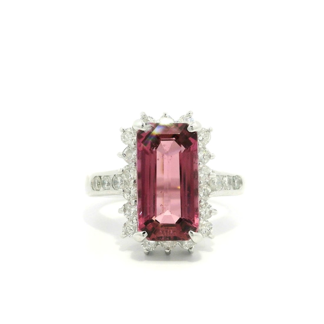 Platinum 4.77ct Long Emerald Cut Pink Tourmaline Diamond Halo Ring: Platinum 4.77ct Long Emerald Cut Pink Tourmaline Diamond Halo Ring This stunning cocktail ring showcases a natural pink tourmaline in a long emerald cut, elegantly prong set and measuring 13.2x6.9mm w