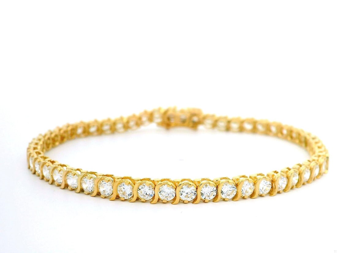 14k Yellow Gold S Link Tennis Bracelet with Cubic Zirconia: 14k Yellow Gold S Link Tennis Bracelet with Cubic Zirconia This exquisite 14k Yellow Gold Tennis Bracelet features a stunning array of (51) round brilliant cut Cubic Zirconia stones, each prong set to