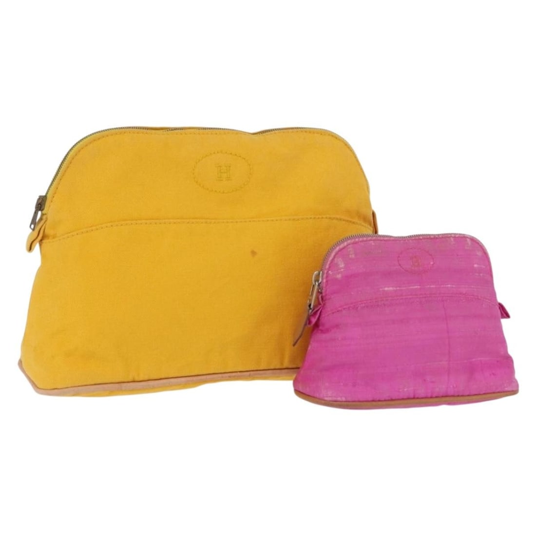 Set of 2 Hermes Canvas Pouches in Yellow and Pink: Set of 2 Hermes Canvas Pouches in Yellow and Pink This is a set of two Hermes pouches crafted from canvas in yellow and pink. Made in France, these pouches show heavy use, with notable loss of shape,