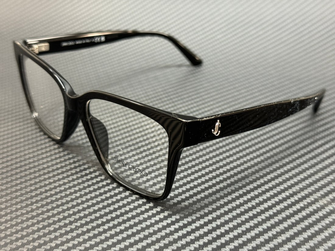 Jimmy Choo JC3006U 5000 Black Eyeglasses with Certificate of Authenticity: Jimmy Choo JC3006U 5000 Black Eyeglasses with Certificate of Authenticity Discover the elegance of Jimmy Choo with these JC3006U 5000 Black Women's Eyeglasses. Featuring a sophisticated black frame an