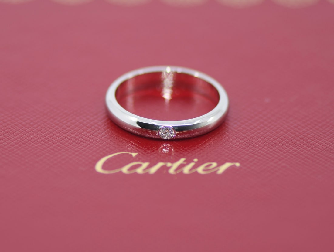 Platinum Diamond Wedding Ring by Cartier Size 59 with Pouch: Platinum Diamond Wedding Ring by Cartier Size 59 with Pouch This Cartier wedding band features a timeless design crafted in platinum with 950 metal purity. The band is adorned with diamonds and is sui