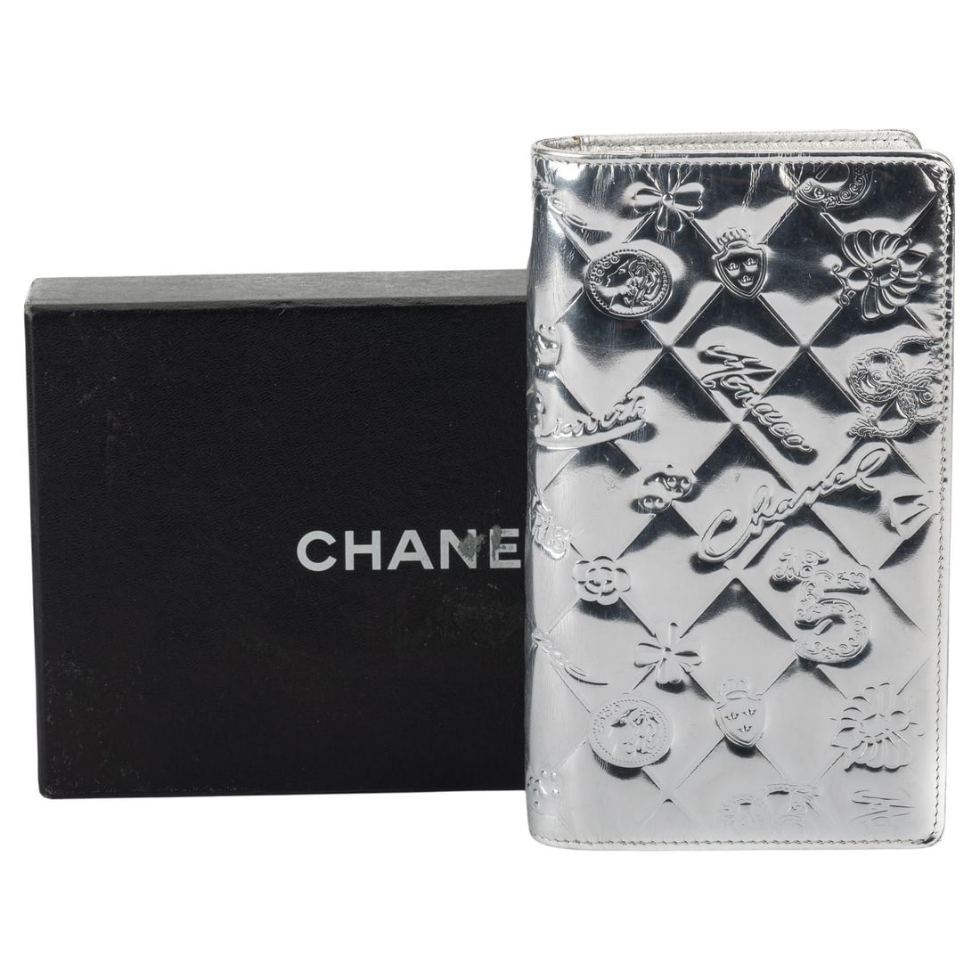 Chanel Silver Symbols Large Wallet with Hologram and Dust Cover: Chanel Silver Symbols Large Wallet with Hologram and Dust Cover This Chanel Preloved Silver Symbols Wallet is a chic accessory featuring a striking silver symbols design. Crafted by the iconic designe