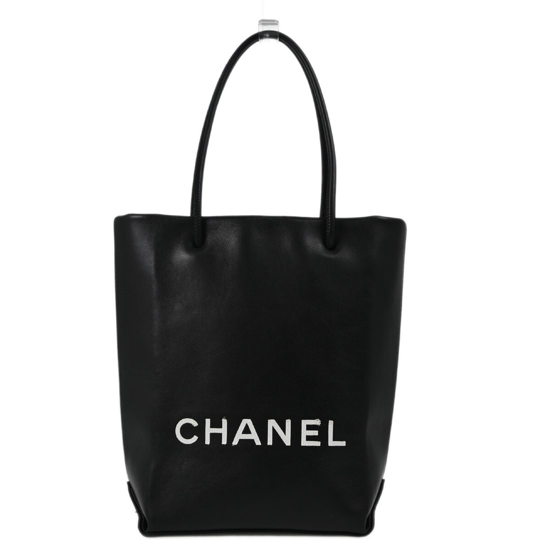 Small Black Calfskin Chanel Essential Tote with Double White Handles: Small Black Calfskin Chanel Essential Tote with Double White Handles This Chanel Essential Tote Bag is crafted from black calfskin leather and features double white handles. The tote is designed for c