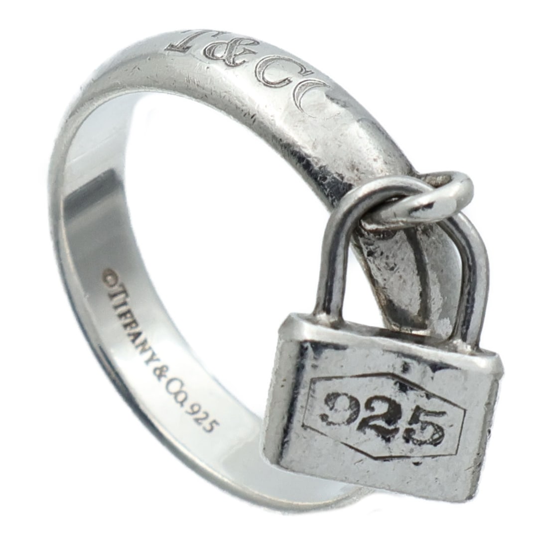 Tiffany Lock Motif Silver 925 Ring Size 5.75: Tiffany Lock Motif Silver 925 Ring Size 5.75 This Tiffany & Co. Lock ring is crafted from 925 sterling silver, featuring a sleek and modern design. The ring has no main stone and is finished in a silv